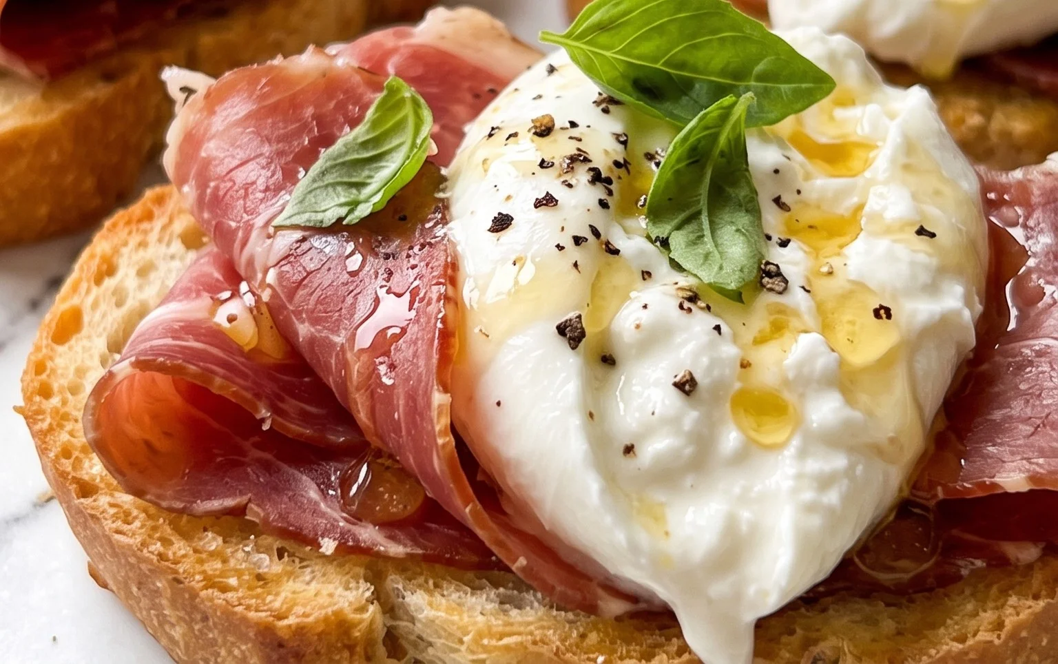 Beef Prosciutto Crostini with Burrata and Lemon Honey Drizzle